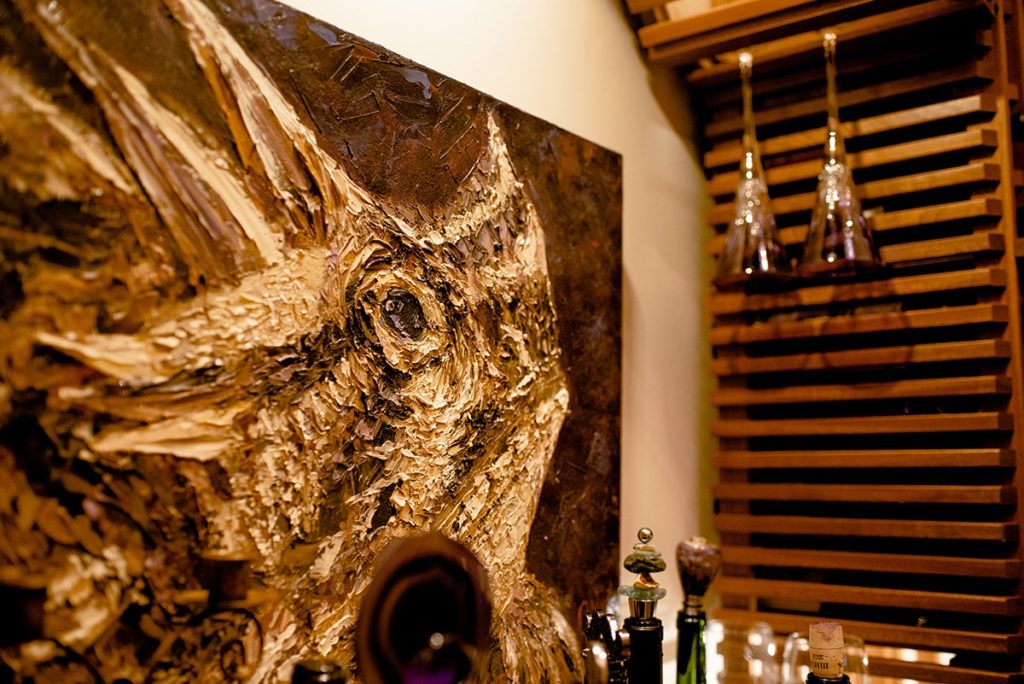 dinosaur painting inside a residential wine cellar in North Dallas
