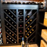 Custom black wooden wine racking are a highly visual way to protect valuable wine bottles.