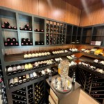 Custom wooden wine racking adds multiple storage options in this transitional home wine cellar.