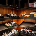 Adjustable LED lighting gives emphasis and mood to this stunning transitional wine cellar.