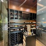 Custom wooden racking allows for multiple wine storage options in this home cellar.