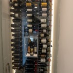 A frameless glass door allows you to easily view the various bottles in the collection.